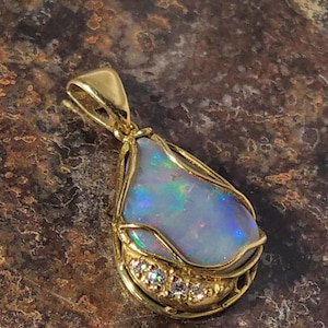 Australian Black Fire Opal Pendant in solid 18 carat gold set with 4 brilliant cut diamonds