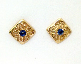 Diamond shaped Flower design stud earring. Set with central cabochon cut Sapphires. In solid  9 carat gold.