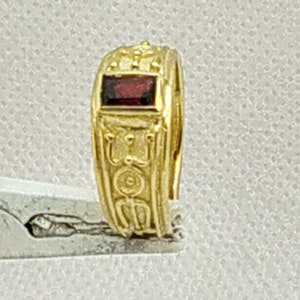 Rectangular Red Garnet set in a   band dress ring,  in 9 carat gold