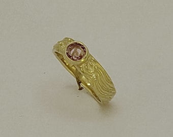 Oval facetted Pink Spinel gemstone in a Band Dress ring, with a beach sand pattern, in 9 K gold