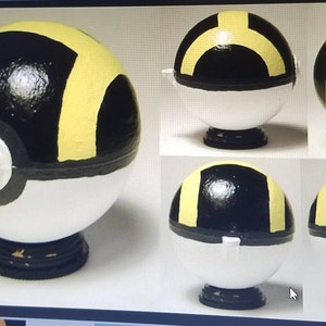 May include: A white, black, and yellow Pokeball with a black base. The Pokeball is painted with a yellow H on the top and a yellow ring around the middle. The Pokeball is shown from multiple angles.