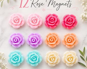 May include: A set of 12 rose-shaped magnets arranged in three rows of four. The magnets feature a variety of colors including light pink, dark pink, purple, orange, turquoise, and cream. The text 12 Rose Magnets is printed at the top.