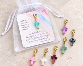 May include: A white organza drawstring bag containing a card with the text A little reminder that He is with you always and Deuteronomy 31:8. Six gold-tone lobster clasp charms with small cross-shaped pendants in blue, purple, black, green, pink, and white.