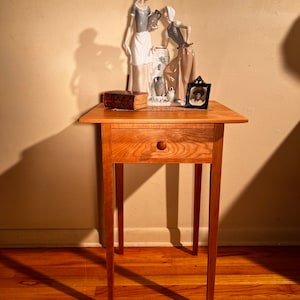 Tapered top and legs for a lighter appearance…cherry;mortise an tenon joinery; hand cut dovetails.