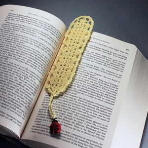 A lovely light yellow crocheted bookmark with a ladybug attached. This bookmark's little ladybug will help you keep your place and give you a smile. Great for gift giving or for yourself. Perfect for the reader in your life.