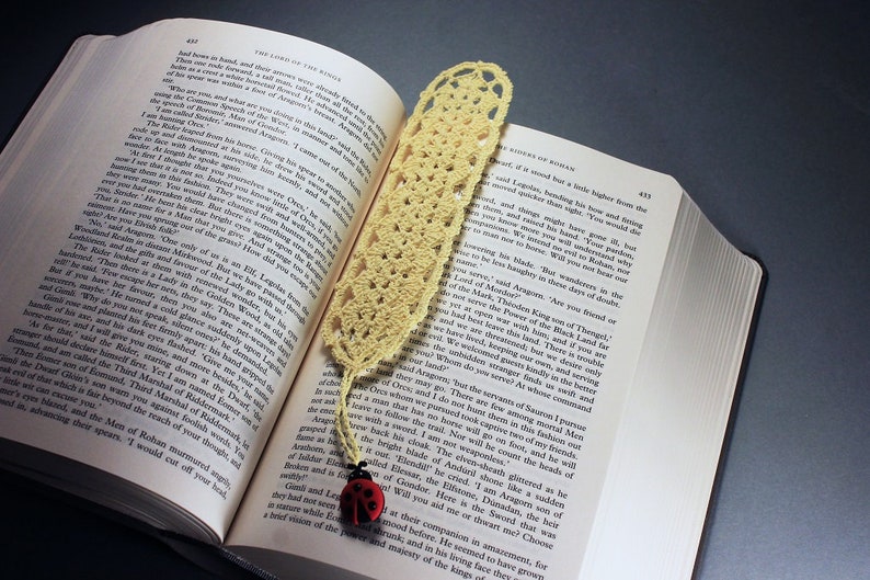 A lovely light yellow crocheted bookmark with a ladybug attached. This bookmark's little ladybug will help you keep your place and give you a smile. Great for gift giving or for yourself. Perfect for the reader in your life.