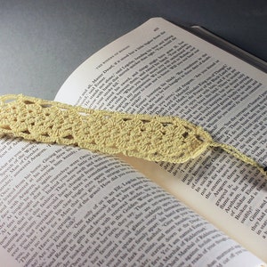 A lovely light yellow crocheted bookmark with a ladybug attached. This bookmark's little ladybug will help you keep your place and give you a smile. Great for gift giving or for yourself. Perfect for the reader in your life.