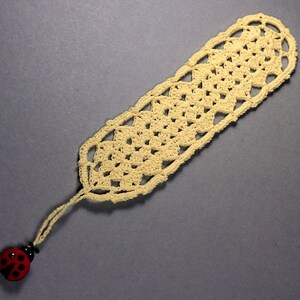 A lovely light yellow crocheted bookmark with a ladybug attached. This bookmark's little ladybug will help you keep your place and give you a smile. Great for gift giving or for yourself. Perfect for the reader in your life.