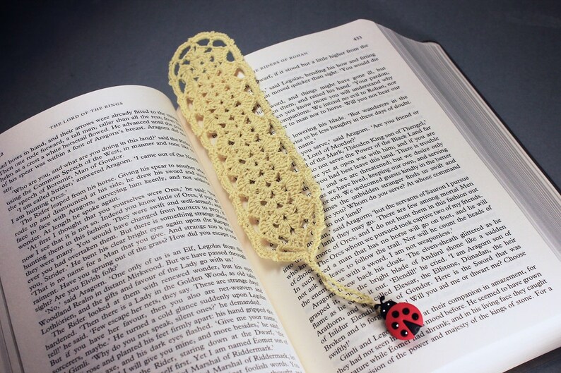 A lovely light yellow crocheted bookmark with a ladybug attached. This bookmark's little ladybug will help you keep your place and give you a smile. Great for gift giving or for yourself. Perfect for the reader in your life.