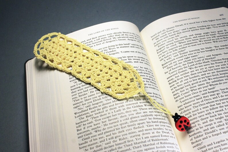 A lovely light yellow crocheted bookmark with a ladybug attached. This bookmark's little ladybug will help you keep your place and give you a smile. Great for gift giving or for yourself. Perfect for the reader in your life.