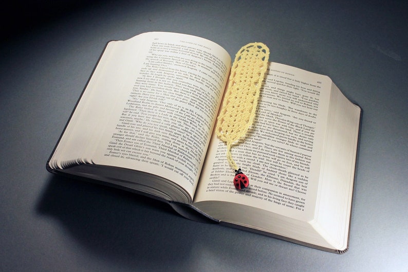 A lovely light yellow crocheted bookmark with a ladybug attached. This bookmark's little ladybug will help you keep your place and give you a smile. Great for gift giving or for yourself. Perfect for the reader in your life.