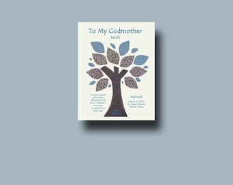 May include: A baptism gift card for a godmother, featuring a tree design with blue and patterned leaves. The text reads "To My Godmother" and "Baptized" with the date and location. The card is set against a light background.