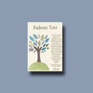 May include: A card with a blue and green tree design and the text "Radwan Tovi" at the top. The card has a message wishing the recipient a happy Bar Mitzvah and a future filled with joy and blessings. The card is signed "With Love, Ethan & Ronit."