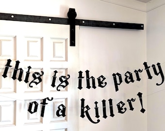 May include: A white door with a black sliding door track and hardware. A banner with the text "this is the party of a killer!" is strung across the door in a gothic font.