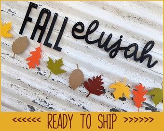 May include: A fall-themed banner with the word "FALL" in bold black letters and the name "Elijah" in cursive. The banner includes colorful paper leaves in shades of yellow, orange, brown, and green. The text "READY TO SHIP" is also visible.