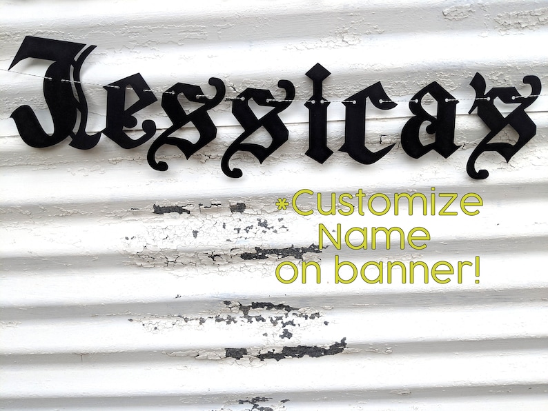 May include: Black metal banner spelling out "Jessica's" in a gothic font. The banner is strung on a thin wire and hangs against a white, weathered, corrugated metal background. Text below reads "Customize Name on banner!"