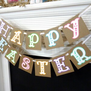 May include: A festive banner spelling "HAPPY EASTER" with colorful letters on brown square cards. The letters are outlined in various colors, including pink, green, and blue, and are strung together with white ribbon, perfect for Easter decorations.