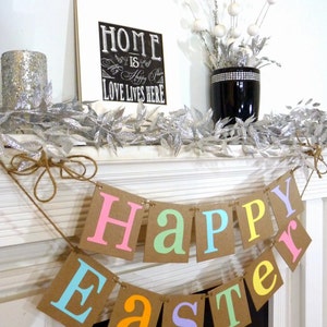 May include: A festive Easter banner with the words "Happy Easter" in pastel colors. The banner is strung on twine and hangs in front of a white fireplace. A framed sign with the text "Home is Happy Place, Love Lives Here" is visible.