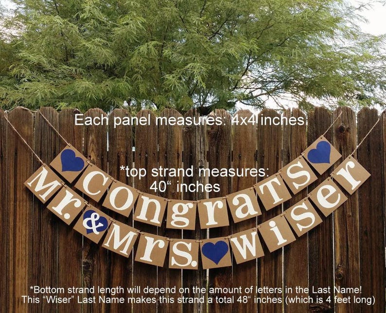 May include: A banner with the words "Mr. & Mrs. Congrats Wiser" in white letters on brown rectangular panels. Each panel is 4x4 inches. Blue hearts accent the design. The top strand measures 40 inches.