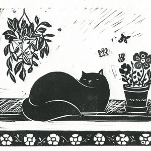 Impressão em linogravura artesanal de um gato e plantas