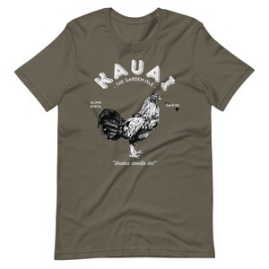 May include: A green t-shirt with a white graphic of a rooster and the text "Kauai - The Garden Isle" with the words "Aloha Kekoa" and "Hawaii" on either side of the rooster. The text "Shaka doodle do!" is below the rooster.