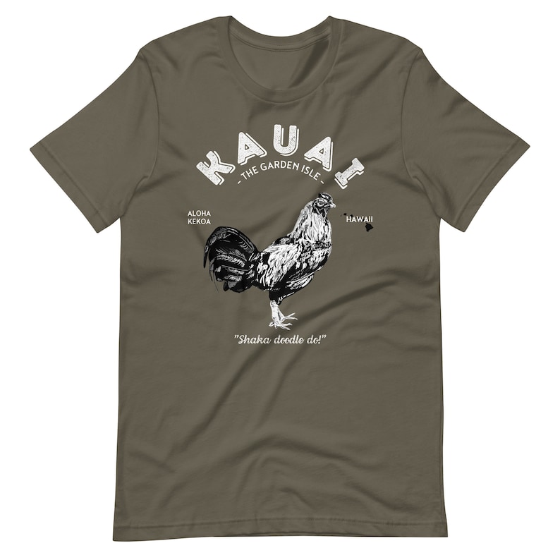 May include: A green t-shirt with a white graphic of a rooster and the text "Kauai - The Garden Isle" with the words "Aloha Kekoa" and "Hawaii" on either side of the rooster. The text "Shaka doodle do!" is below the rooster.