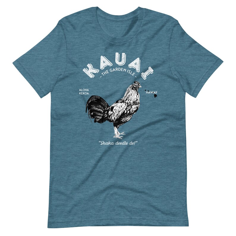 May include: A teal blue t-shirt with a white graphic of a rooster and the text "Kauai - The Garden Isle - Aloha Kekoa - Hawaii - Shaka doodle do!"
