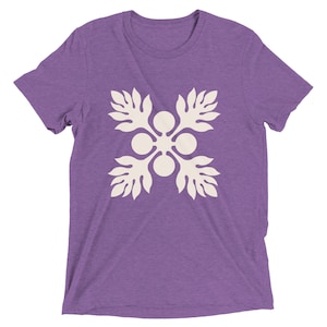 May include: Purple short-sleeved t-shirt with a white floral design.