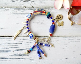 Mixed media bracelet with feather and butterfly charms and African trade beads, eclectic jewelry, Unique bead bracelet with toggle clasp