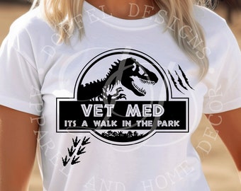May include: White t-shirt with a black graphic of a dinosaur and the text "Vet Med It's a walk in the park".