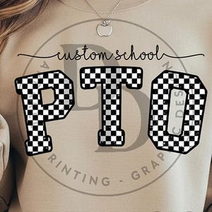 May include: Beige sweatshirt with a black and white checkered "PTO" design. The words "custom school" are above the letters, and "PRINTING - GRAP" is printed in a circle below the letters.