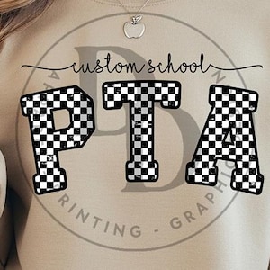 May include: A beige sweatshirt featuring the letters "PTA" in a black and white chequered design. The words "custom school" are above the letters, and "PRINTING - GRAPHICS" are below, in a circular design.