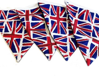 May include: A set of five triangular fabric flags with a Union Jack design. The flags feature a white background with a blue and red pattern. The text "Dark Union Jack - Large" is at the bottom.