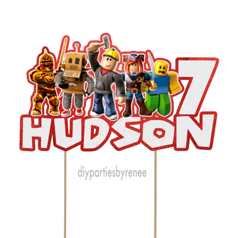 May include: Red and white cake topper with the name "HUDSON" and the number "7" in white with red glitter. There are five Roblox characters on the topper, including a knight, a robot, a construction worker, a pirate, and a character wearing a blue shirt. The topper is on two wooden sticks.