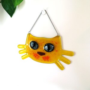 Yellow Cat-shaped fused glass sun-catcher with sparkling eyes