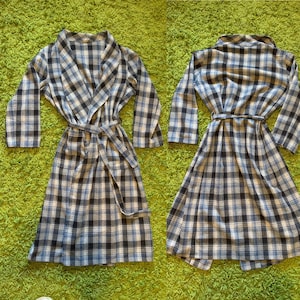 May include: A blue and white plaid robe with a long sleeve and a sash tie.