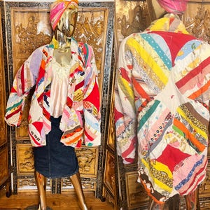 May include: A colorful patchwork jacket with a unique design. The jacket features a variety of fabric patterns and colors, including red, yellow, pink, and blue. The jacket is displayed on a mannequin. The back of the jacket is also visible, showcasing the intricate patchwork.