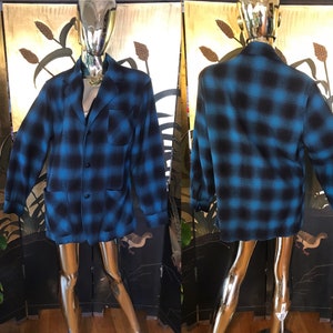 May include: A blue and black plaid flannel jacket with two pockets and a button closure.