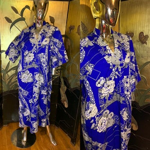 May include: A blue and white patterned kimono-style robe with a V-neck and short sleeves. The robe has a geometric and floral design.