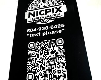 May include: Black rectangular card with white text and a QR code. The card features the logo "NICPIX LASER ENGRAVING" and the phone number 804-938-6425 with the text "*text please*".