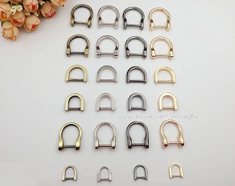May include: Assortment of 18 gold, silver, and black metal D-rings in various sizes. The D-rings are arranged in rows on a white surface. www.etsy.com/shop/lacecrafted