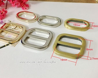 May include: Four metal slider buckles in gold and silver. The buckles are rectangular and oval shaped. The larger buckles measure 1.9 inches by 1.8 inches and 1.9 inches by 0.9 inches. The smaller buckles measure 0.4 inches by 1 inch and 0.4 inches by 0.4 inches.
