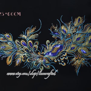 May include: A large peacock feather design applique with gold and blue sequins. The applique measures 125 inches by 60 inches.