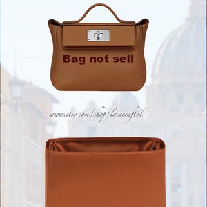 May include: A brown leather handbag with a silver clasp and the text "Bag not sell" printed on the front. The bag is shown with a brown fabric insert.