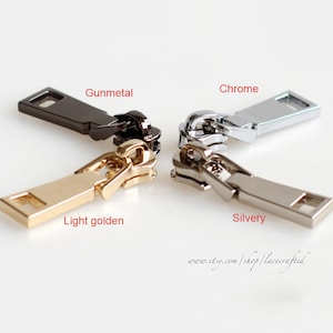 Op de afbeelding: Vier ritsen in verschillende afwerkingen: gunmetal, chroom, licht goud en zilver.