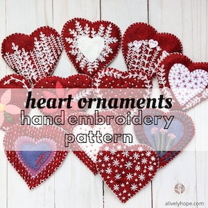 May include: A collection of red felt heart ornaments with various white embroidery designs, including snowflakes, flowers, and stars. The text "heart ornaments hand embroidery pattern" is displayed on a white background.