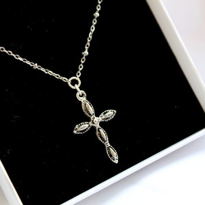 Antique silver necklace with small detailed cross charm on stainless steel satellite chain