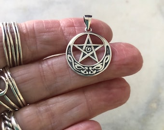 May include: Silver pendant featuring a pentacle with a spiral design inside, surrounded by a Celtic knot border.