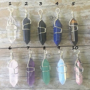 May include: Ten different wire-wrapped crystal pendants, each with a different color and type of crystal. The crystals are arranged in two rows of five, with numbers 1 through 10 labeling each pendant.