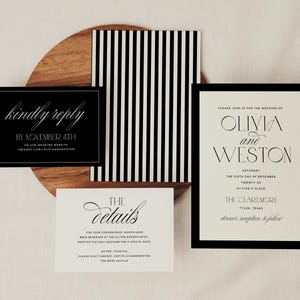 May include: Elegant wedding invitation suite featuring a black and white color scheme. Includes a main invitation with the names "Olivia and Weston", a details card, and a reply card. The design incorporates a striped pattern and a wooden accent.